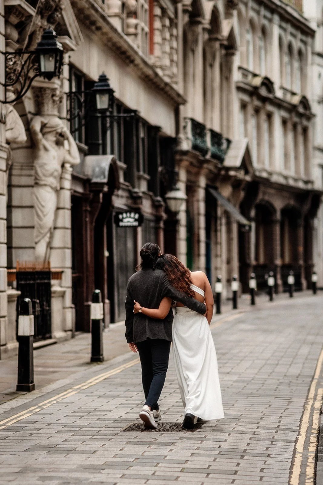 A bride and groom romantically walking down the streets of the Netherlands taken by wedding photographer Darius N Fernandes