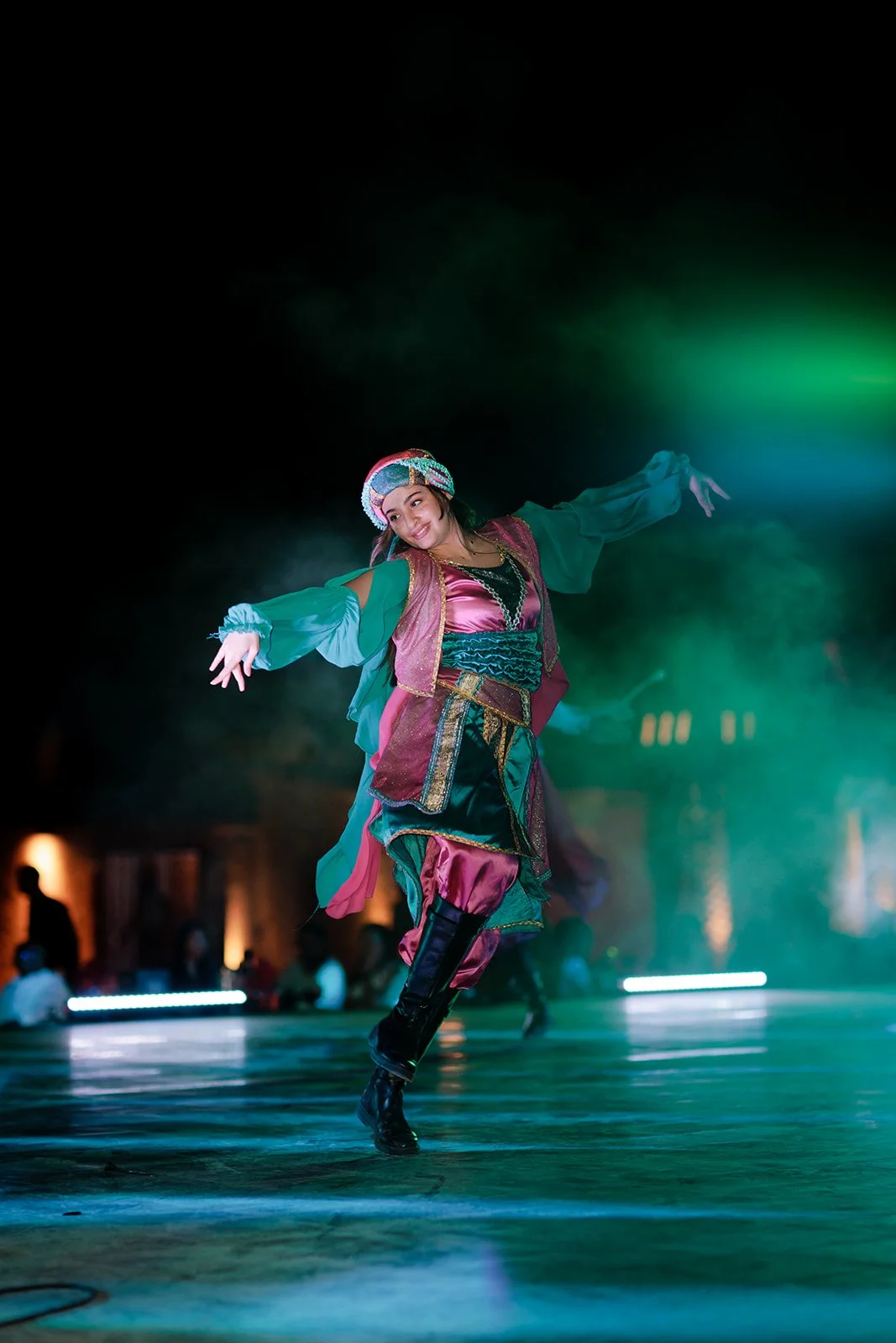 A event photograph of a lady dancing in traditional Middle eastern attire, by Darius N Fernandes