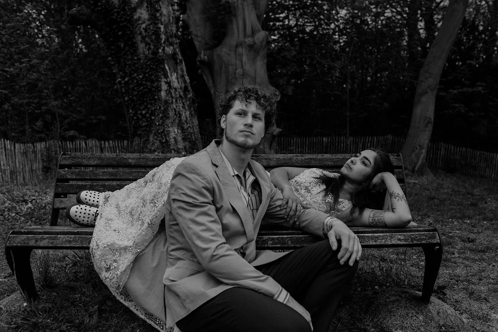 A couple elegantly posed on a bench by Darius N Fernandes