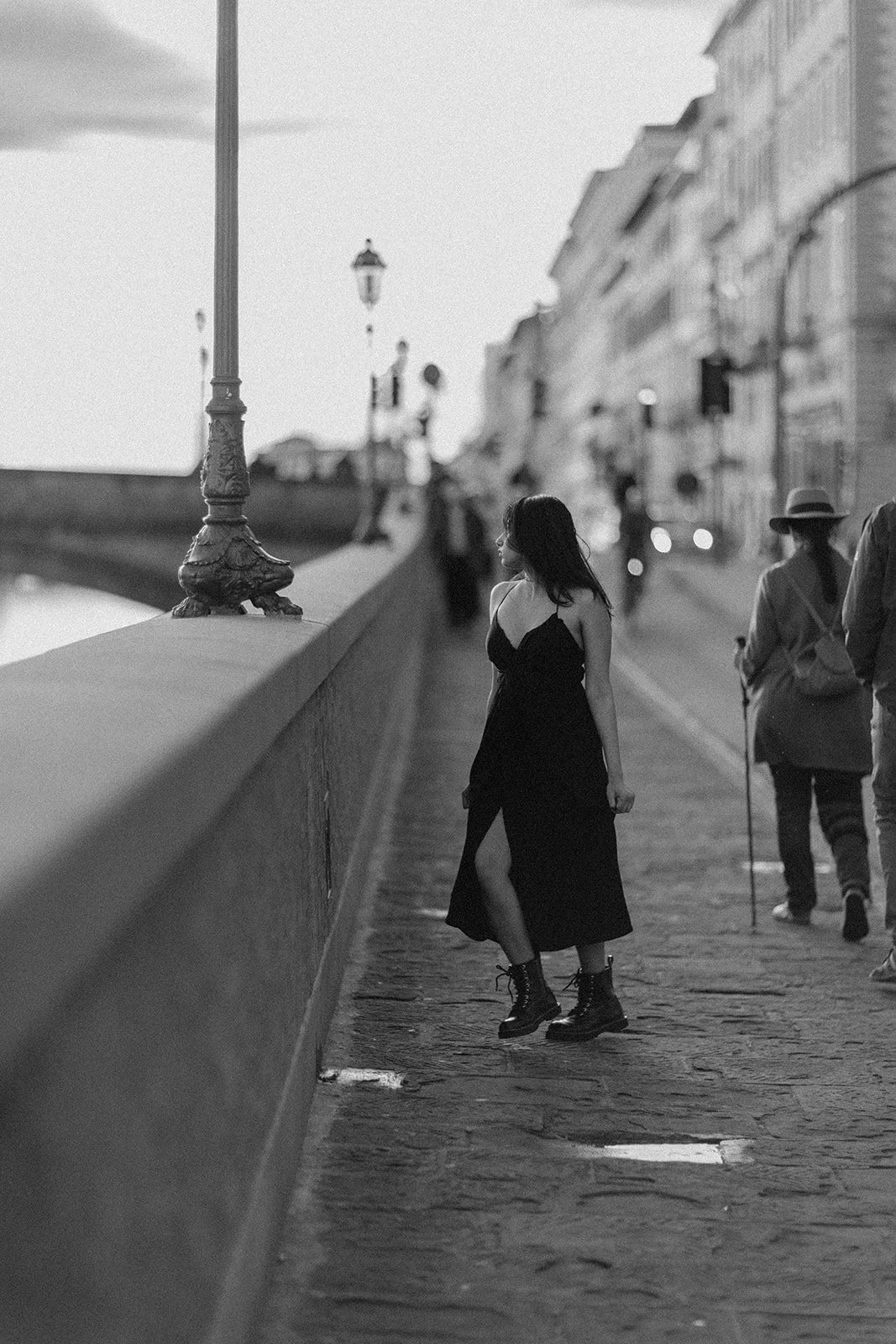 An Aesthetic  portrait of a lady walking down an old medieval street in the Netherlands, by Darius
