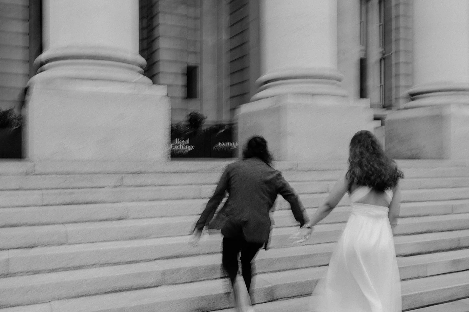 A bride and groom caught in motion running and having a nice time