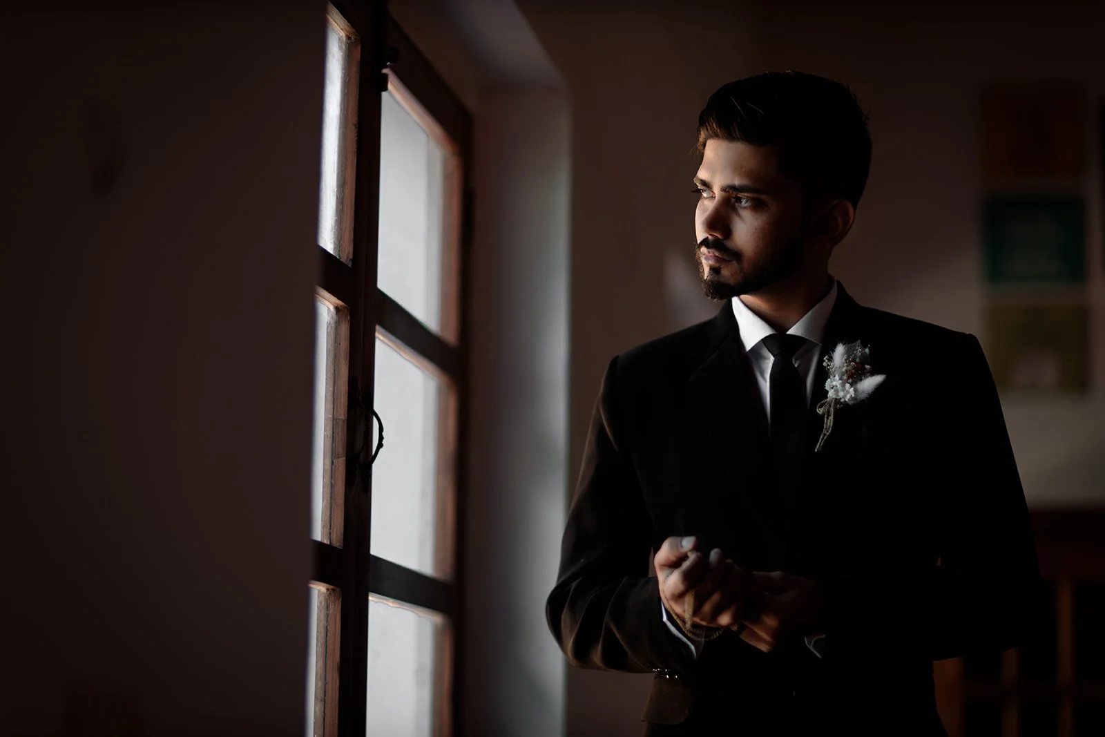 A portrait photograph of Darius N Fernandes standing by the window