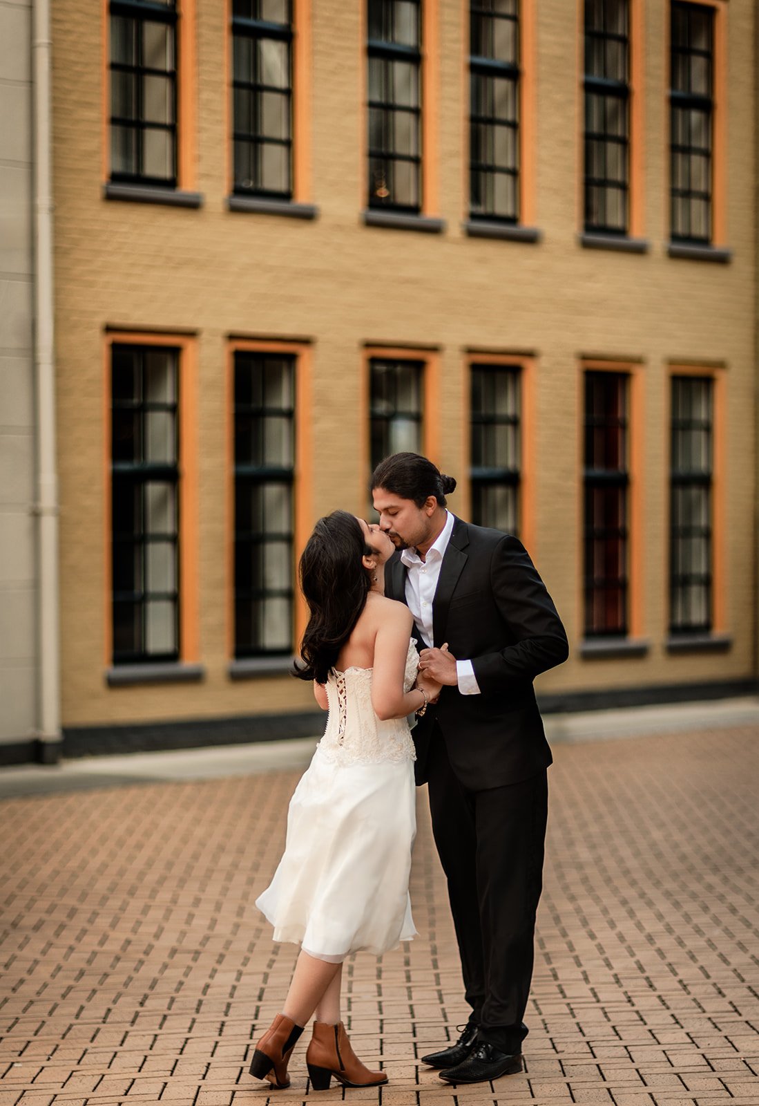 A couple sharing a kiss on the streets of Groningen taken by wedding photographer Darius N Fernandes