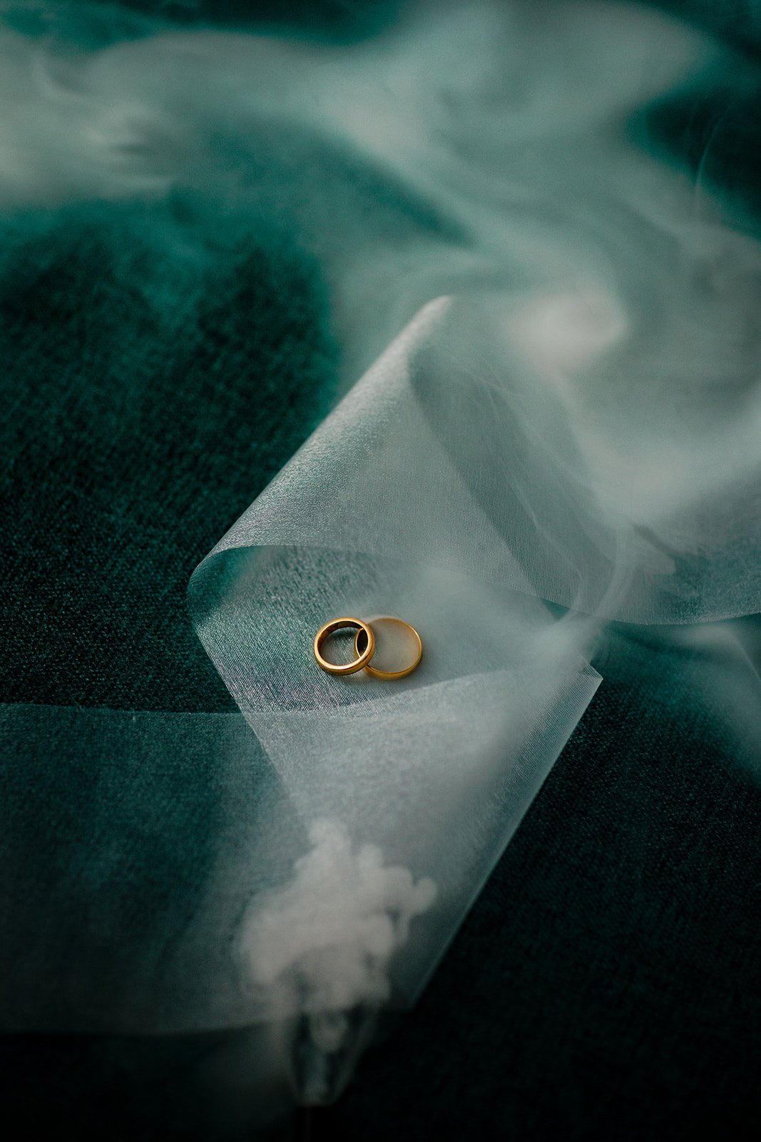 A photograph of the wedding rings with smoke running through the dutch fabric