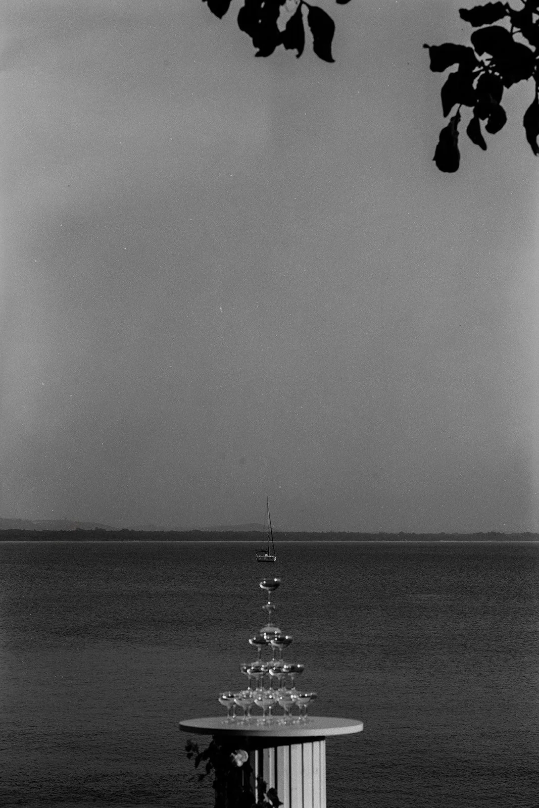 A photograph of a champagne tower aligned with a Yatch taken at a wedding by Darius N Fernandes