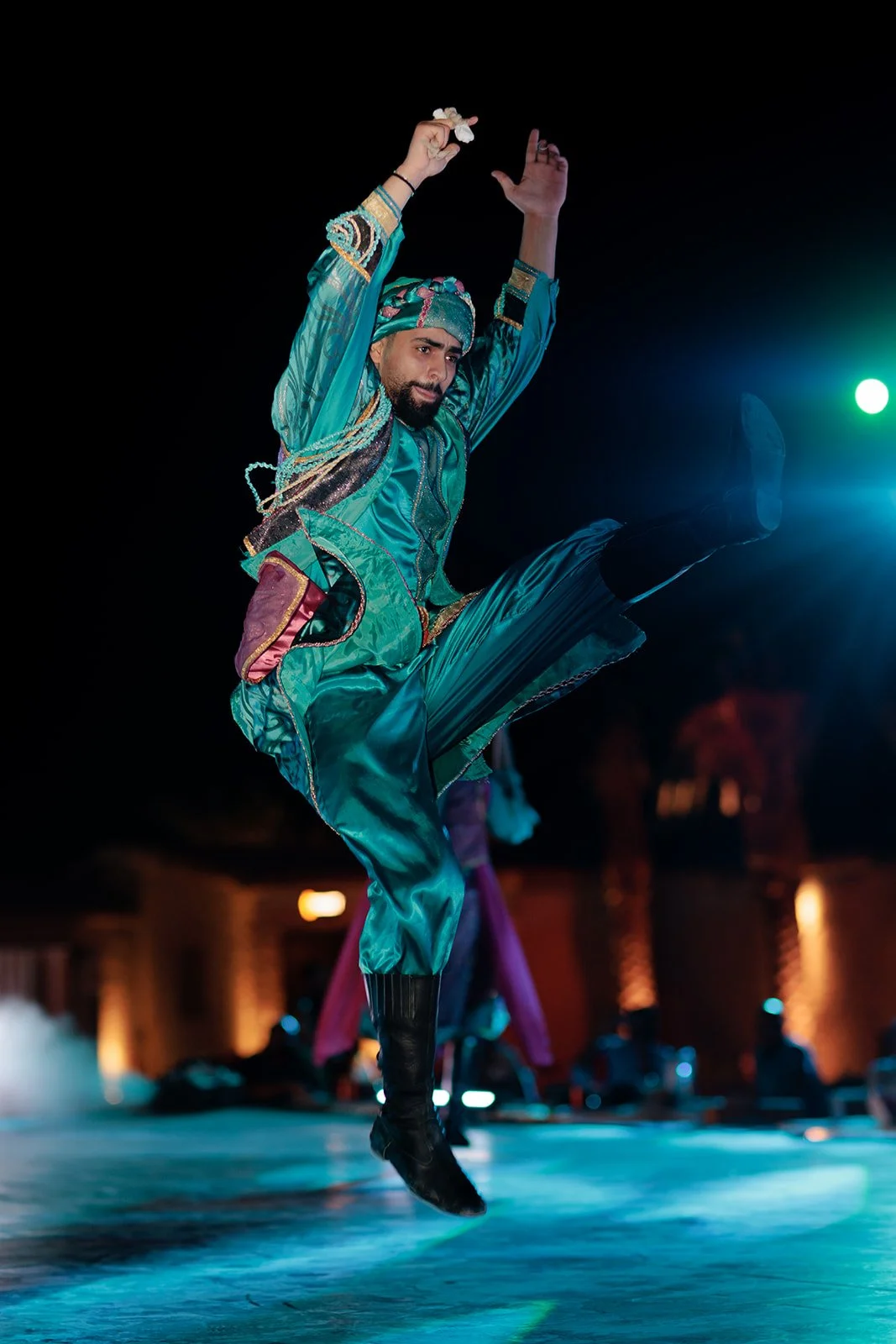 Darius N Fernandes Captures an event photograph of a middle eastern dancer mid jump in a blue outfit