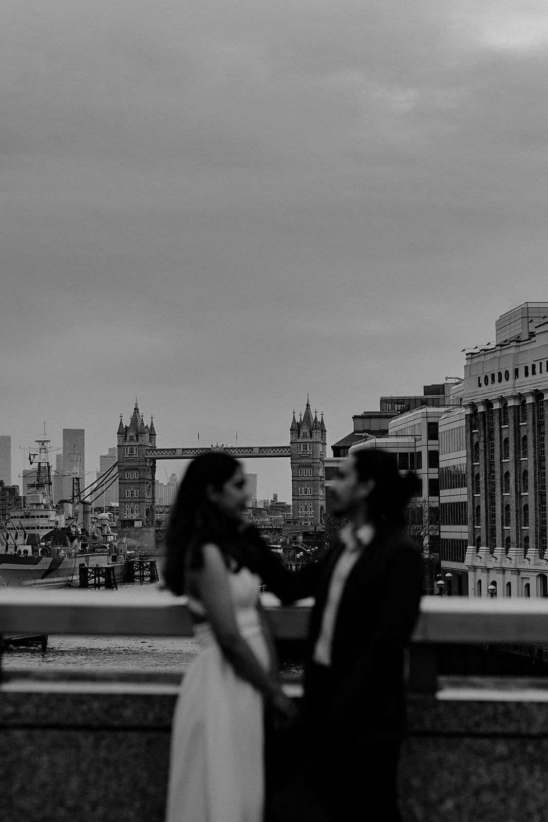 A photograph of a couple enjoying a moment by the bridge taken by wedding photographer Darius N Fernandes