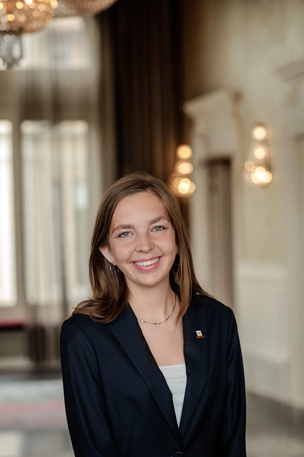 A headshot portrait photograph of a lady in blue blazer shot by Darius N Fernandes