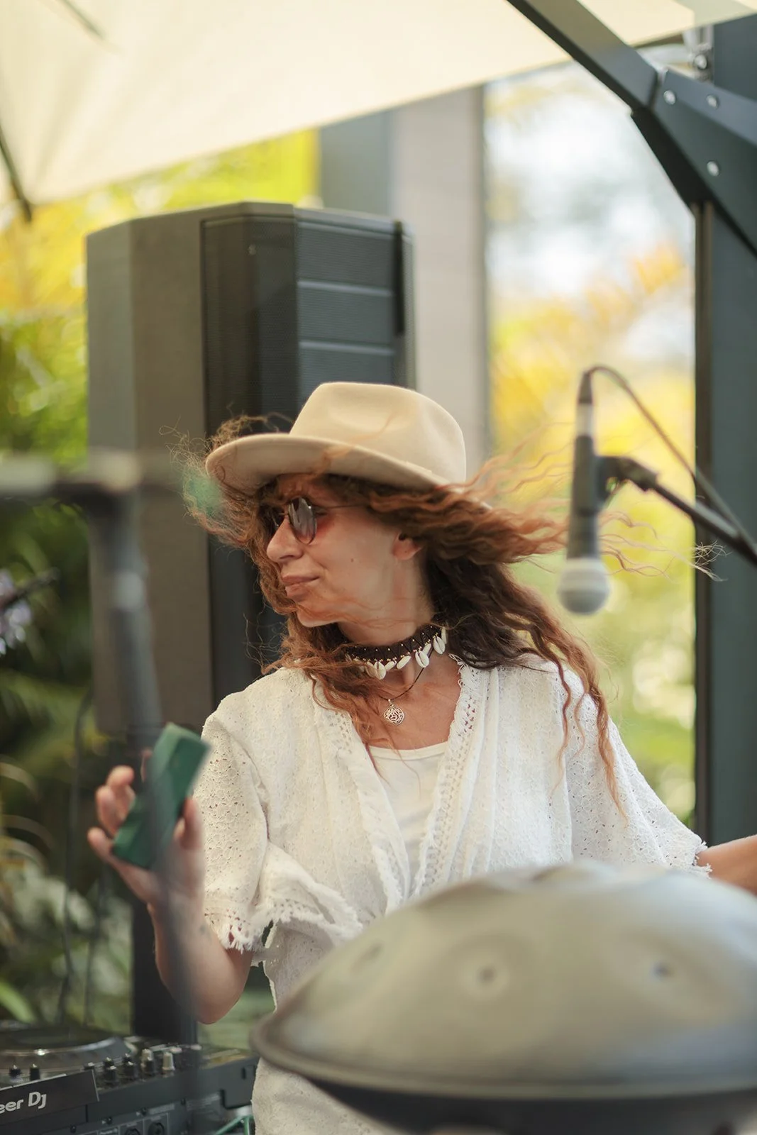 A lady playing a green instrument for the crowd  at an event that Darius N Fernandes Photographed 