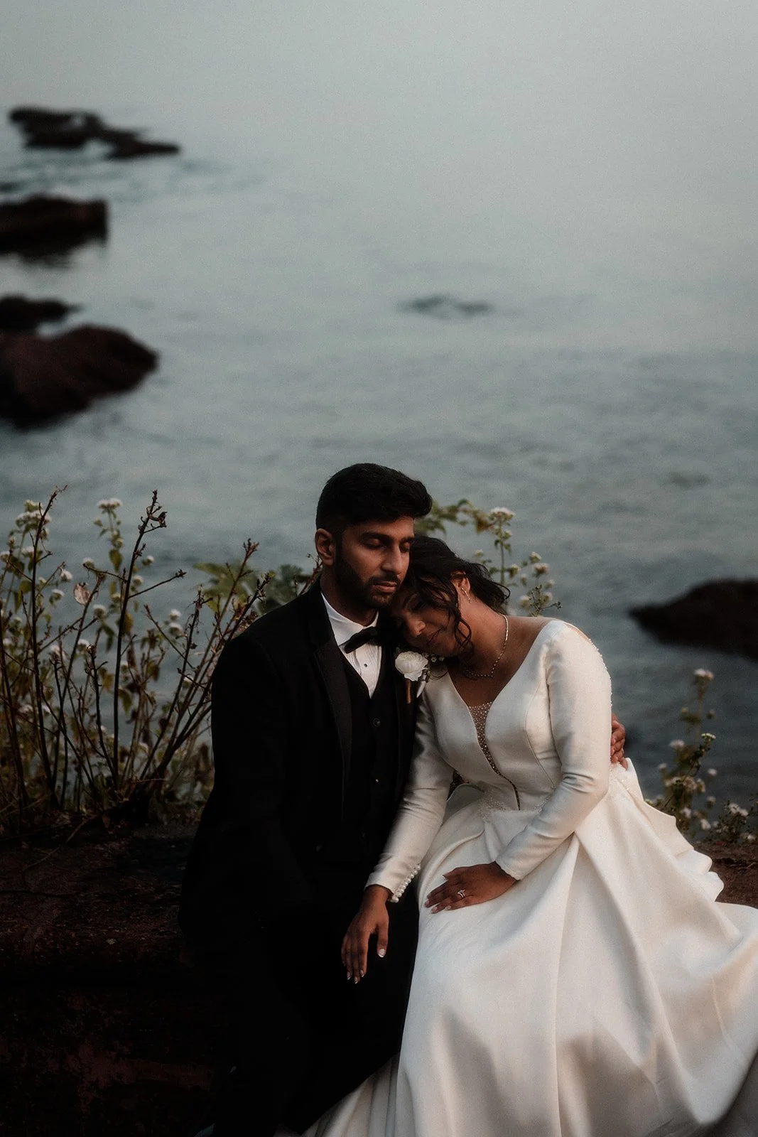 A photograph of a couple enjoying the calm of the sea in the background before the wedding begins, taken by Darius