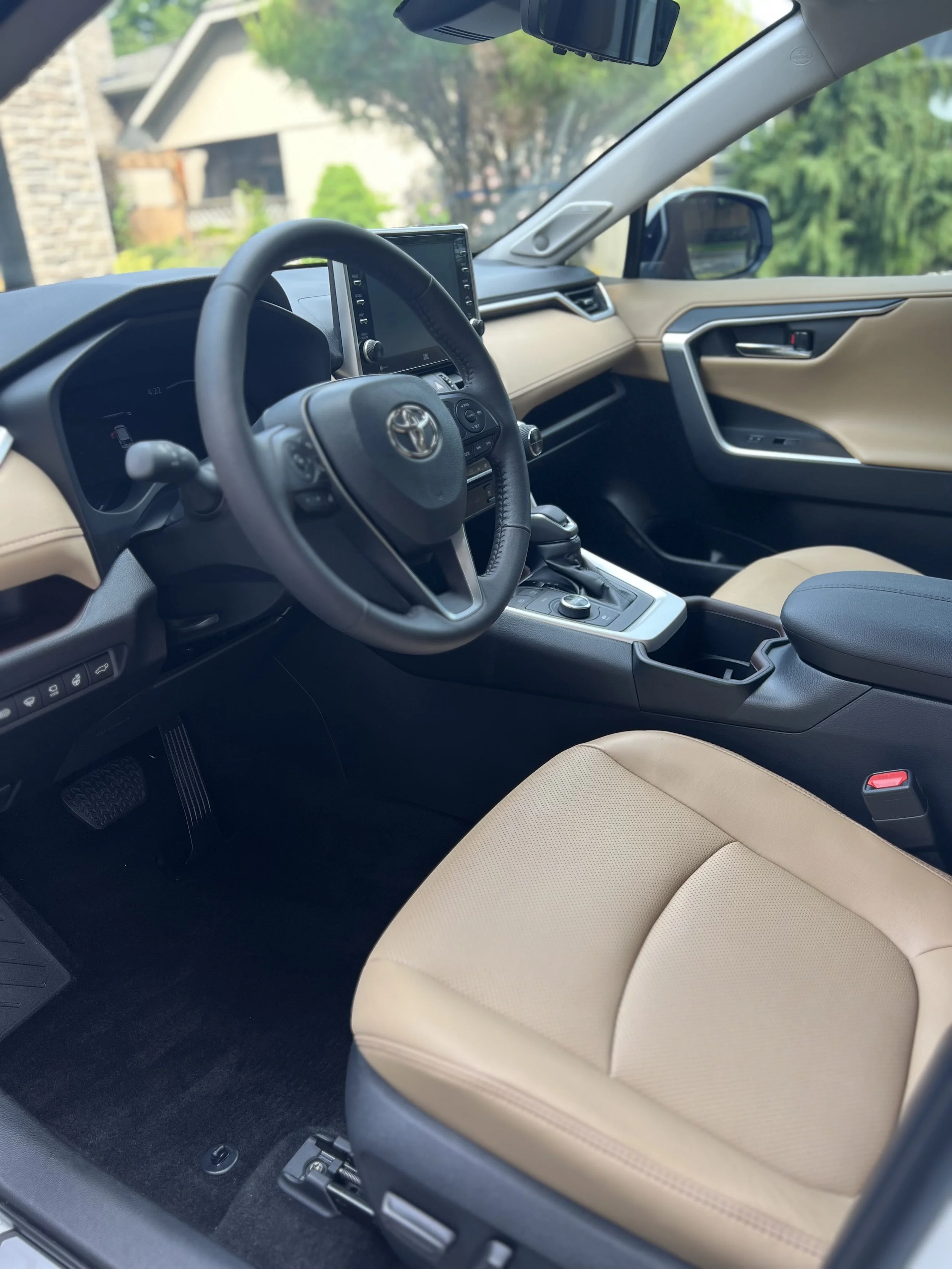 The interior of a toyota sedan  showing a beige leather seat, car interior detailing dashboard and seats deep clean Toronto