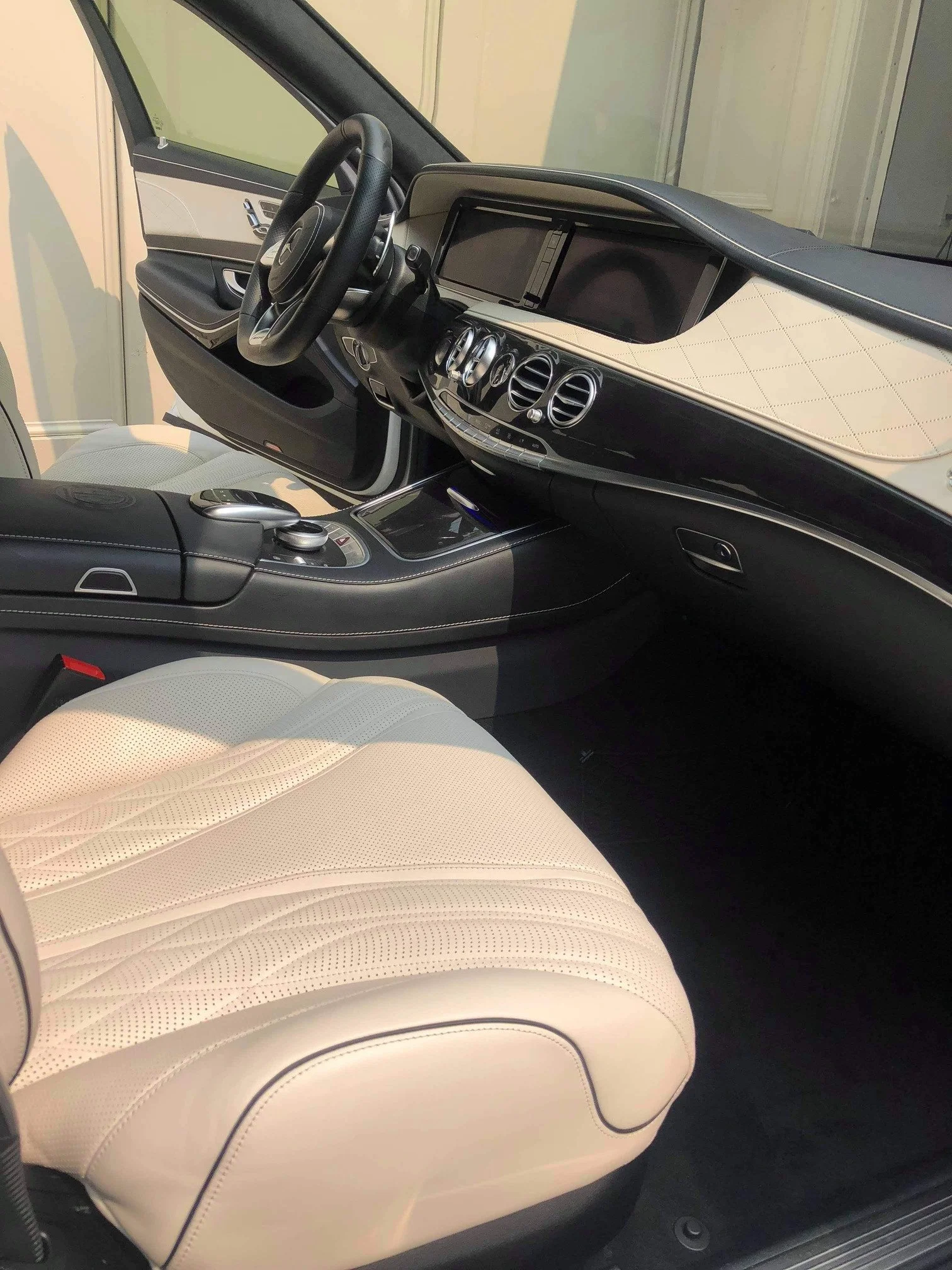 The interior of a luxury car showing a beige leather seat, car interior detailing dashboard and seats deep clean Toronto