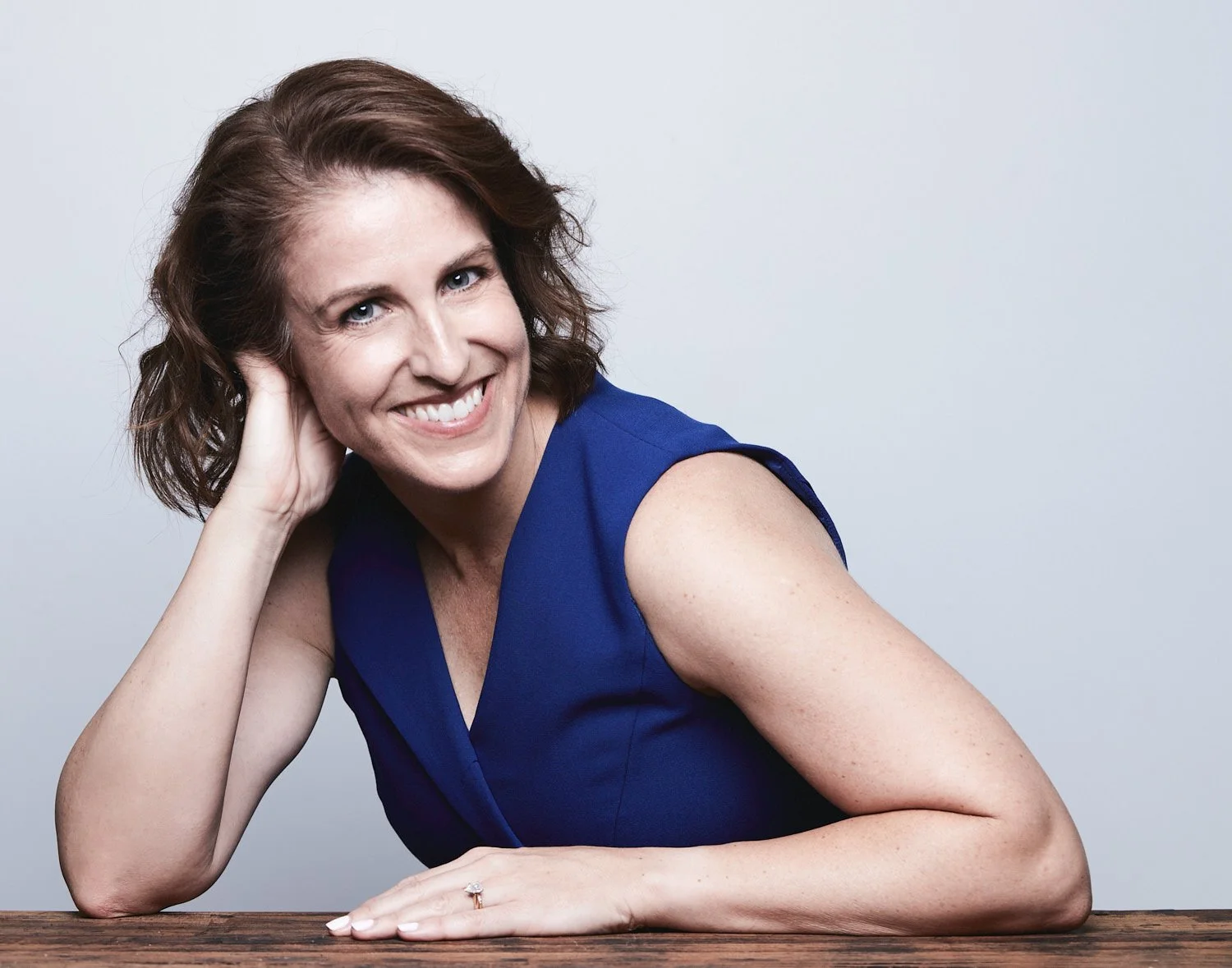 Portrait of Melanie smiling in blue dress