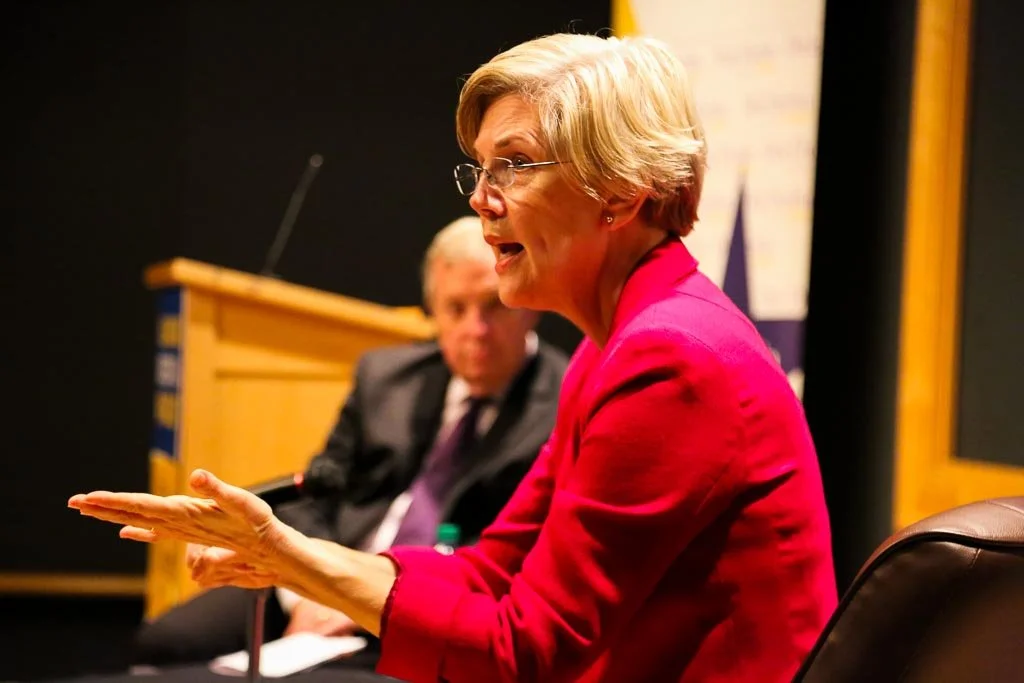 A woman is speaking at a conference.