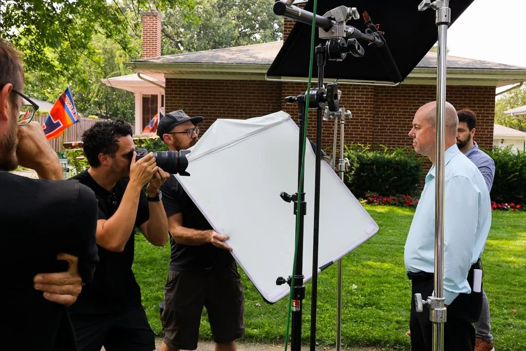 Photographers filming a man.
