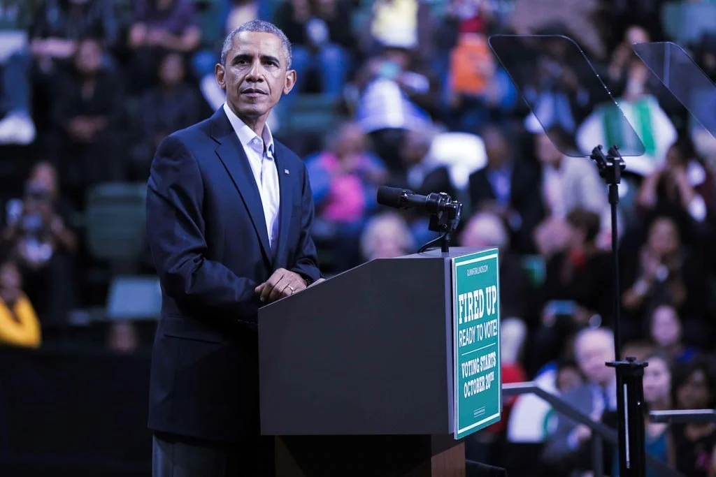 Barack Obama standing at a podium.