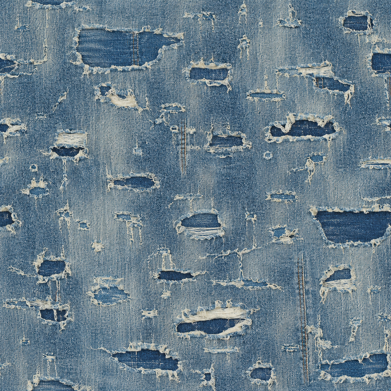 Close-up of distressed blue denim fabric with multiple frayed holes.