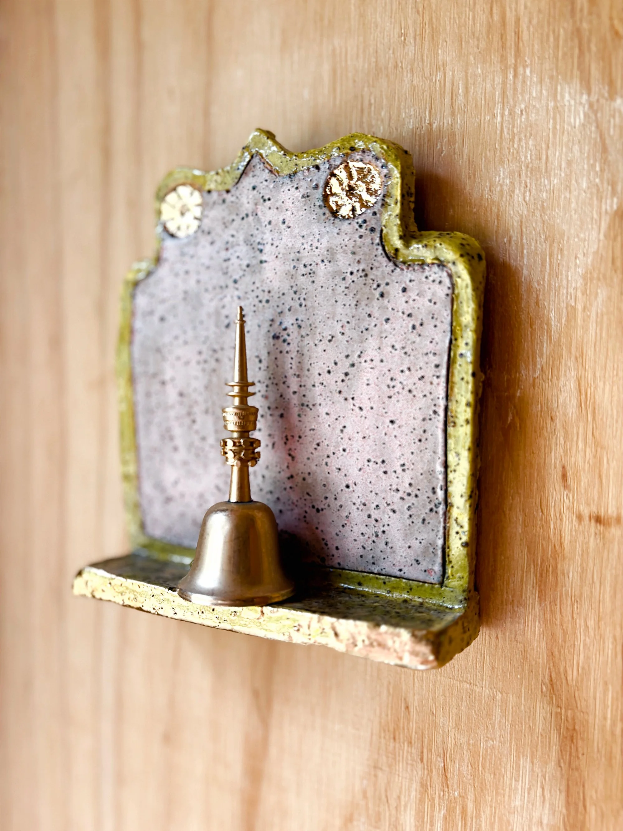 Life Alters - 'Ring for Champagne' 

Hand-built slab ceramic wall artwork, BRT mid-fire clay, underglaze, clear gloss glaze and gold lustre detail. 16cm h x 13cm w x 4cm d. 

Inspired by the ‘buchette del vino’ (wine walls) of Florence—tiny windows i