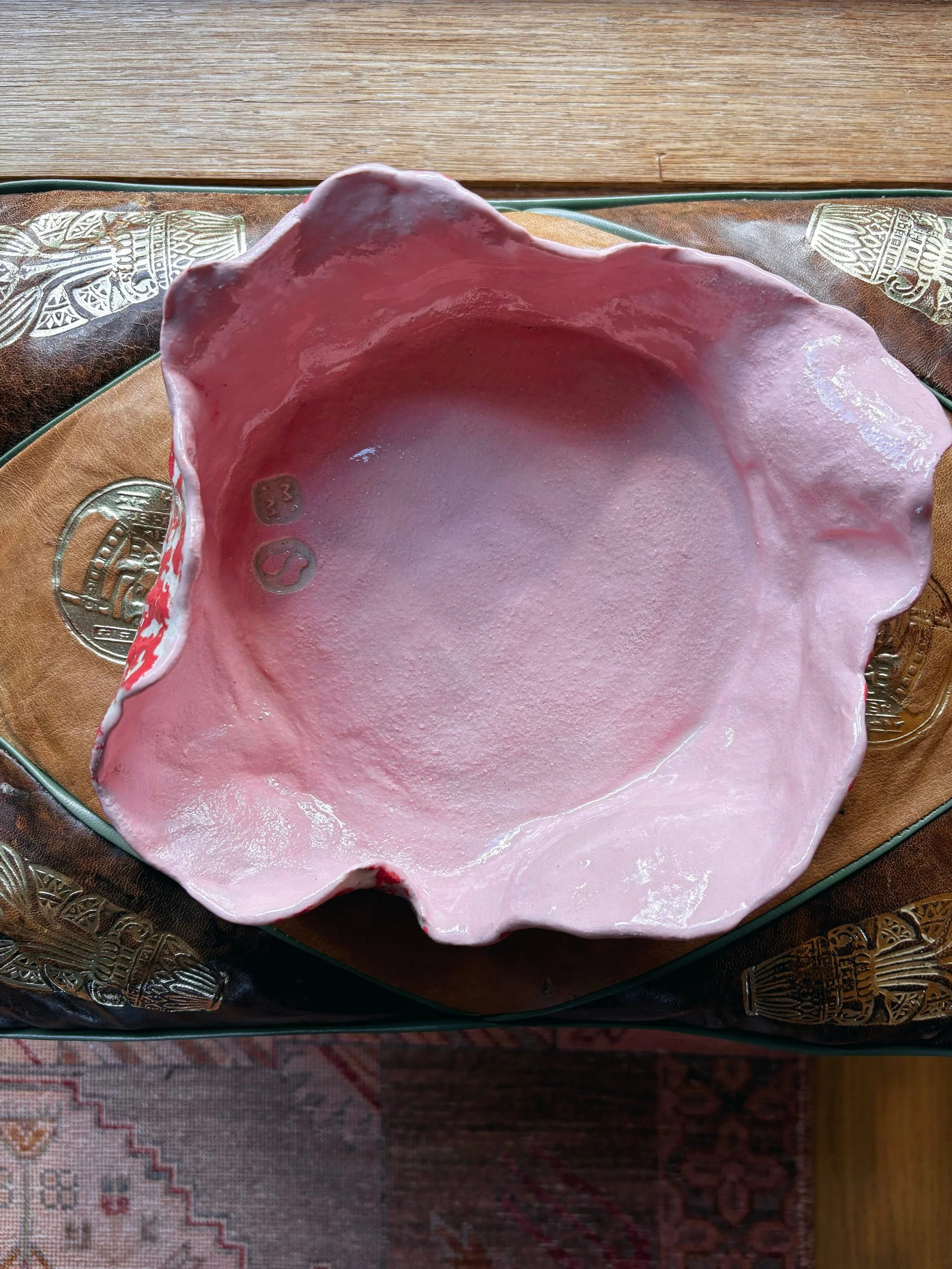 Hand-built, sculptural, pink and red glazed sculptural pasta bowl for two.