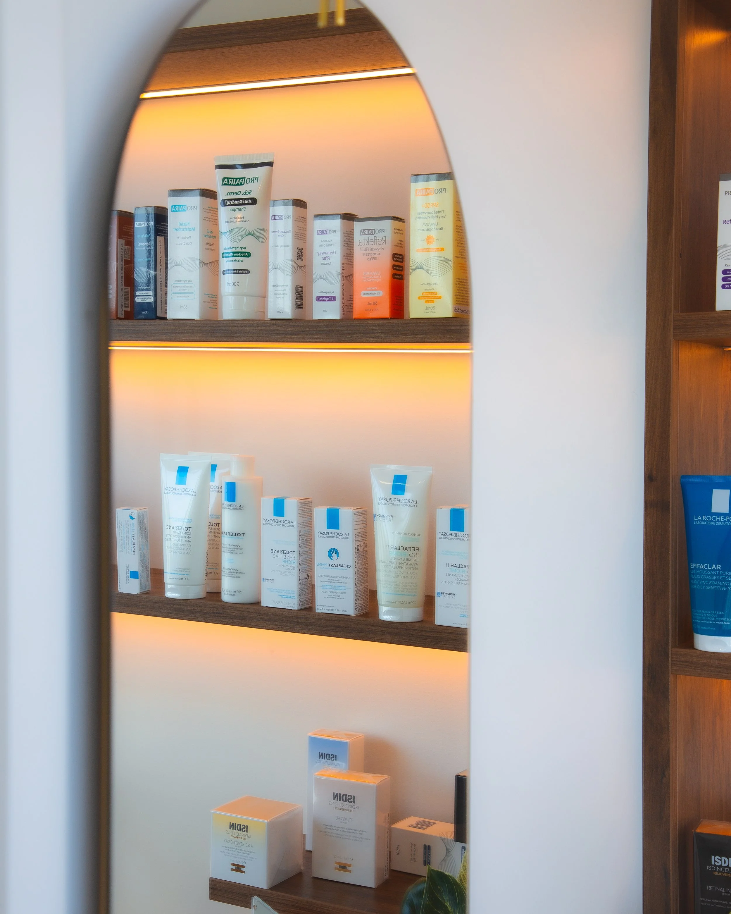 Shelf with skincare products, including creams and serums, in a retail store.