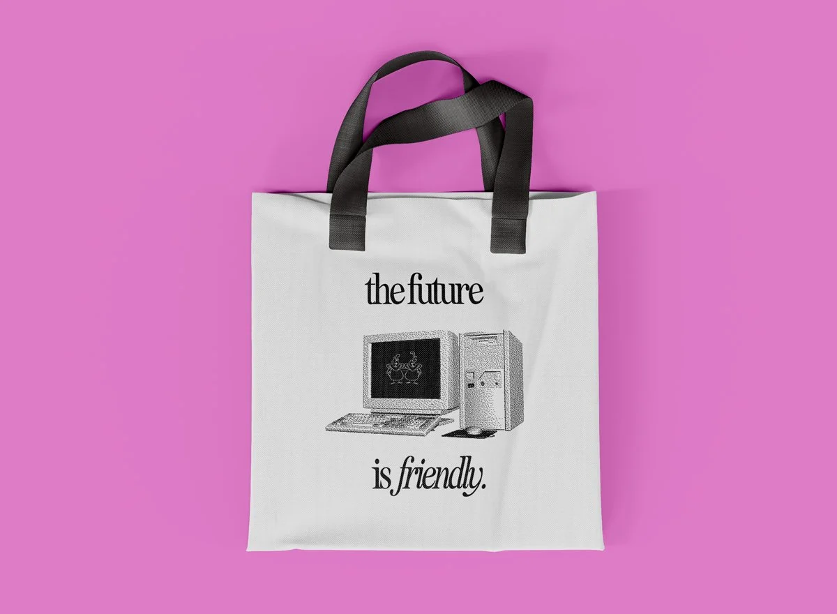flat lay mockup of a tote bag featuring a custom design with a retro style computer and italic fonts