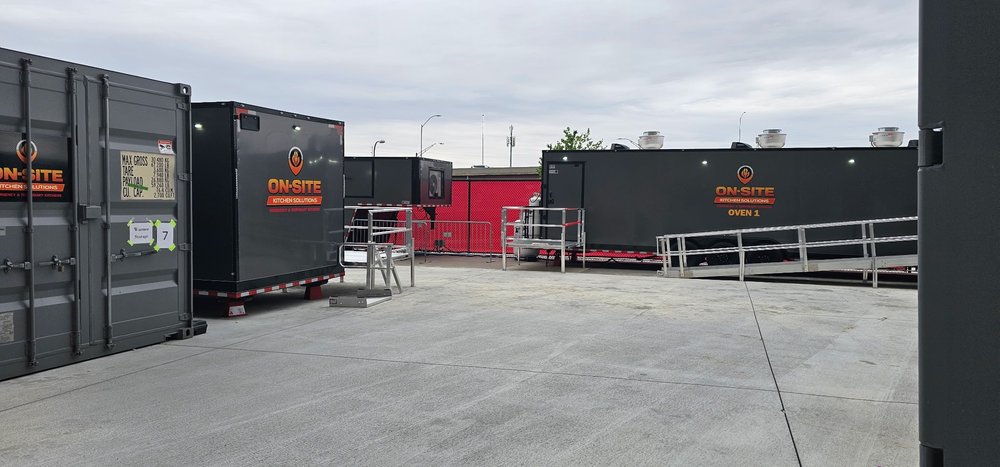 On-Site Kitchen Solutions temporary kitchen compound deployed on site with oven and prep trailers