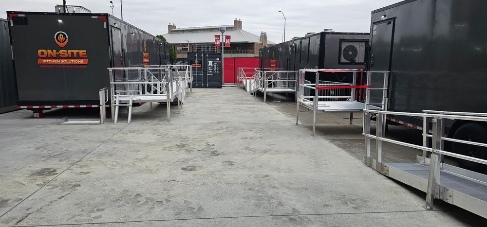 On-Site Kitchen Solutions mobile kitchen trailers and storage containers staged on site