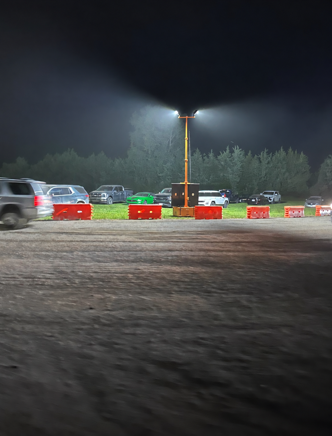 Solar light tower illuminating a parking lot at night