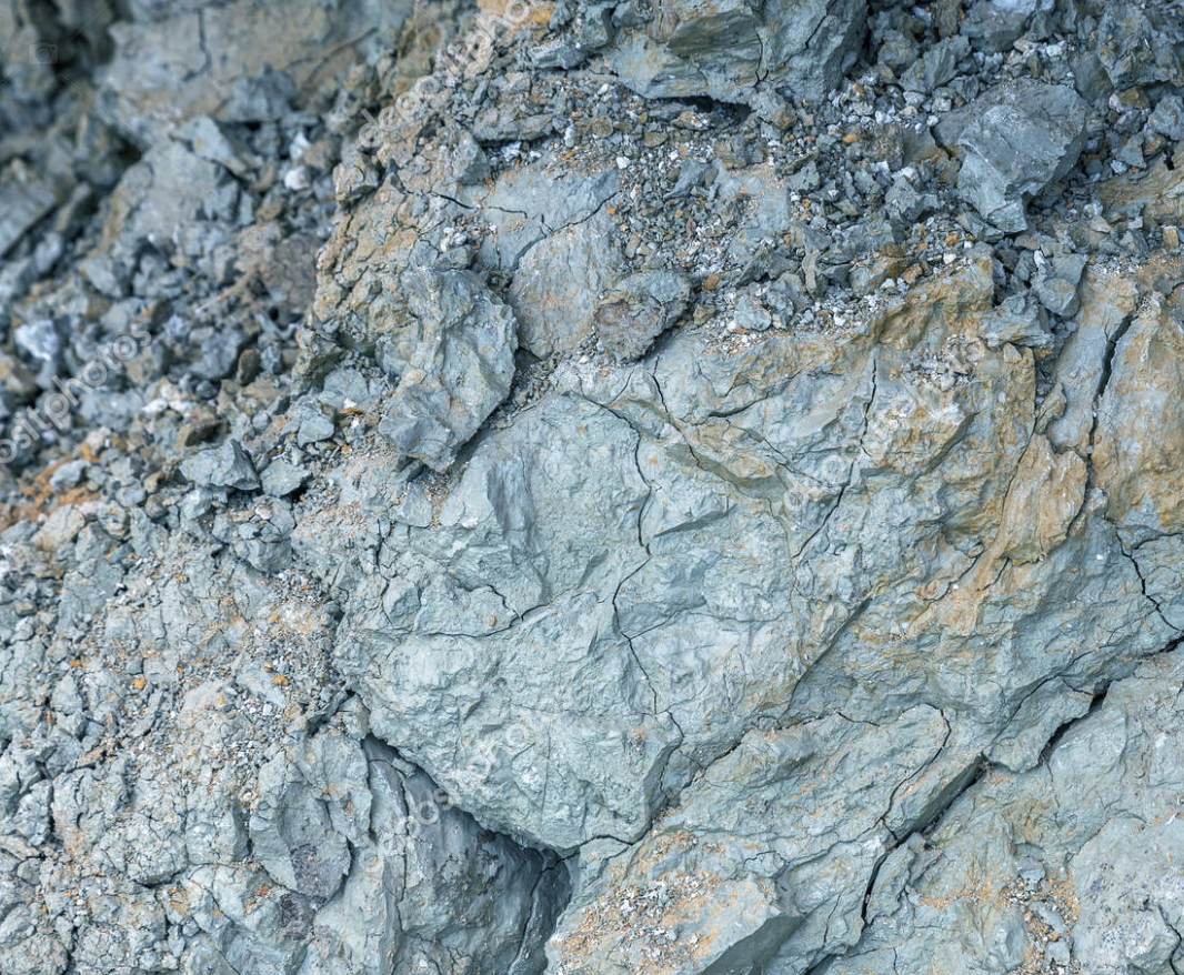 Close-up of gray and brown rocky surface with cracks.
