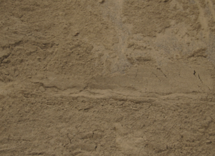 Close-up of a textured beige stone wall