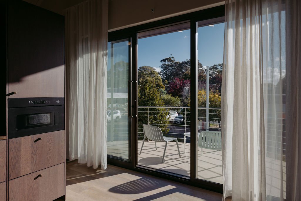 Private balcony suite at Sola Studios Margaret River with natural light, outdoor seating and elevated views designed for relaxed couples escapes.