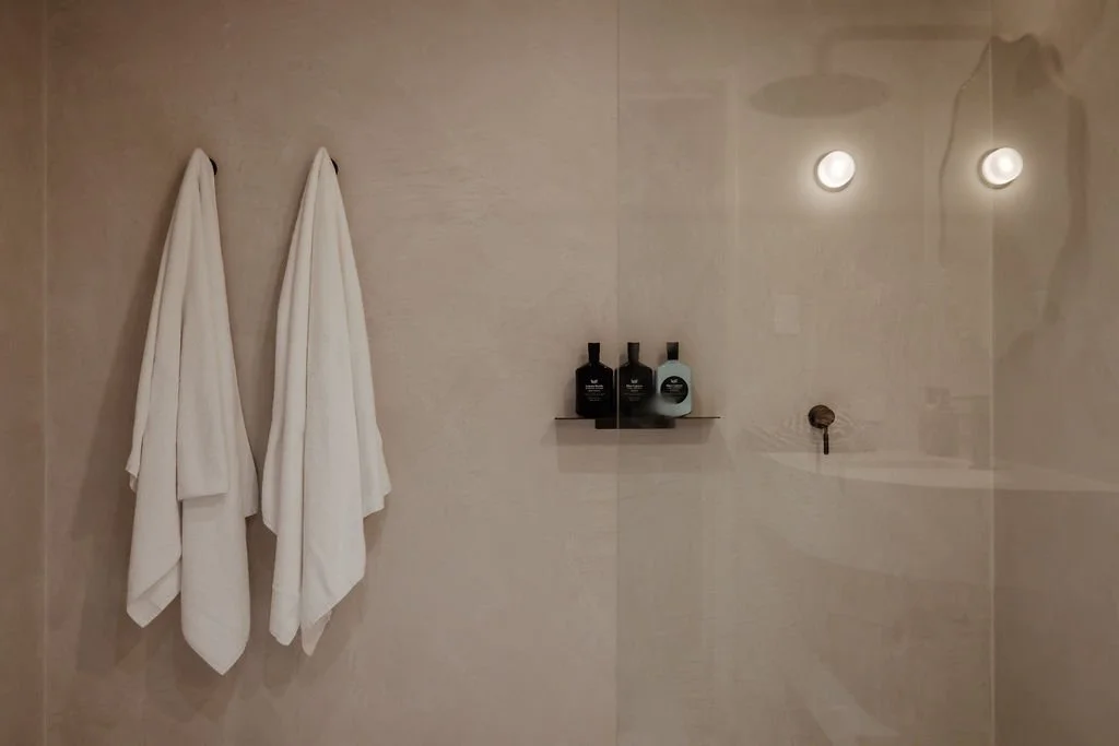 Minimalist bathroom at Sola Studios Margaret River with stone finishes, soft lighting and boutique amenities inspired by refined hotel stays.