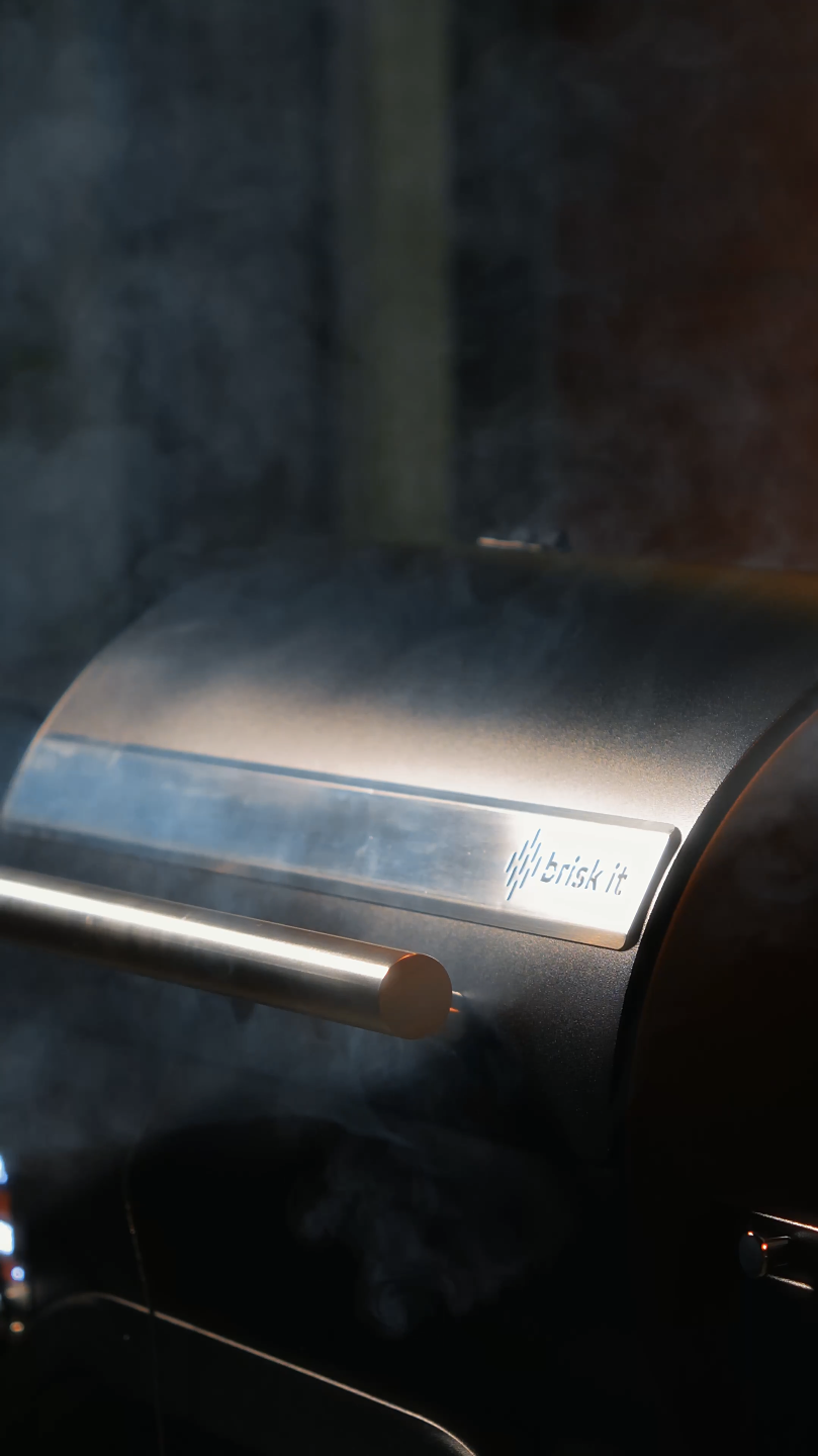 Close-up of a brushed stainless steel commercial grill or griddle with a metal handle and branding that reads 'thrifty' in small font.