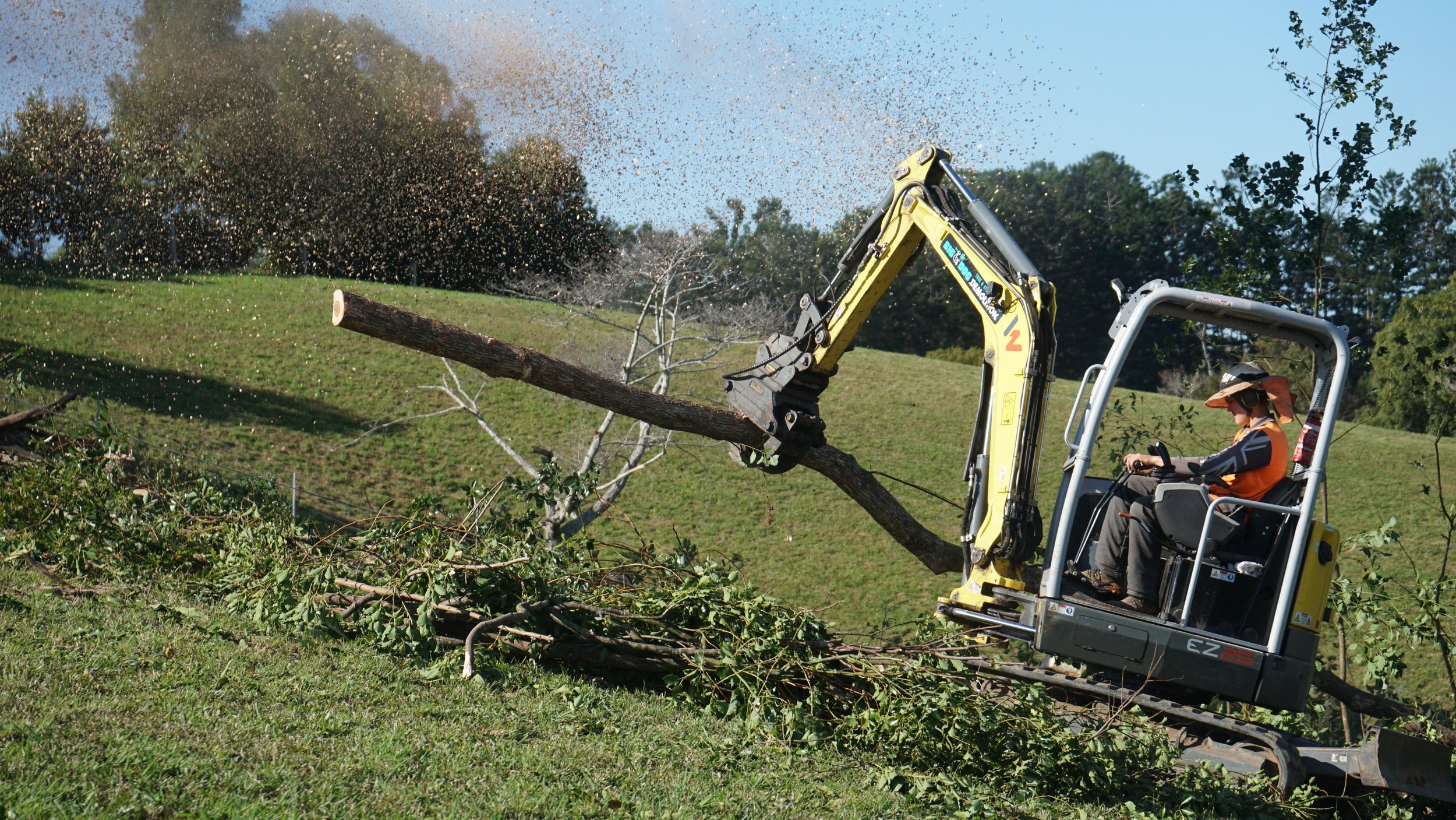 Moving branches with digger 