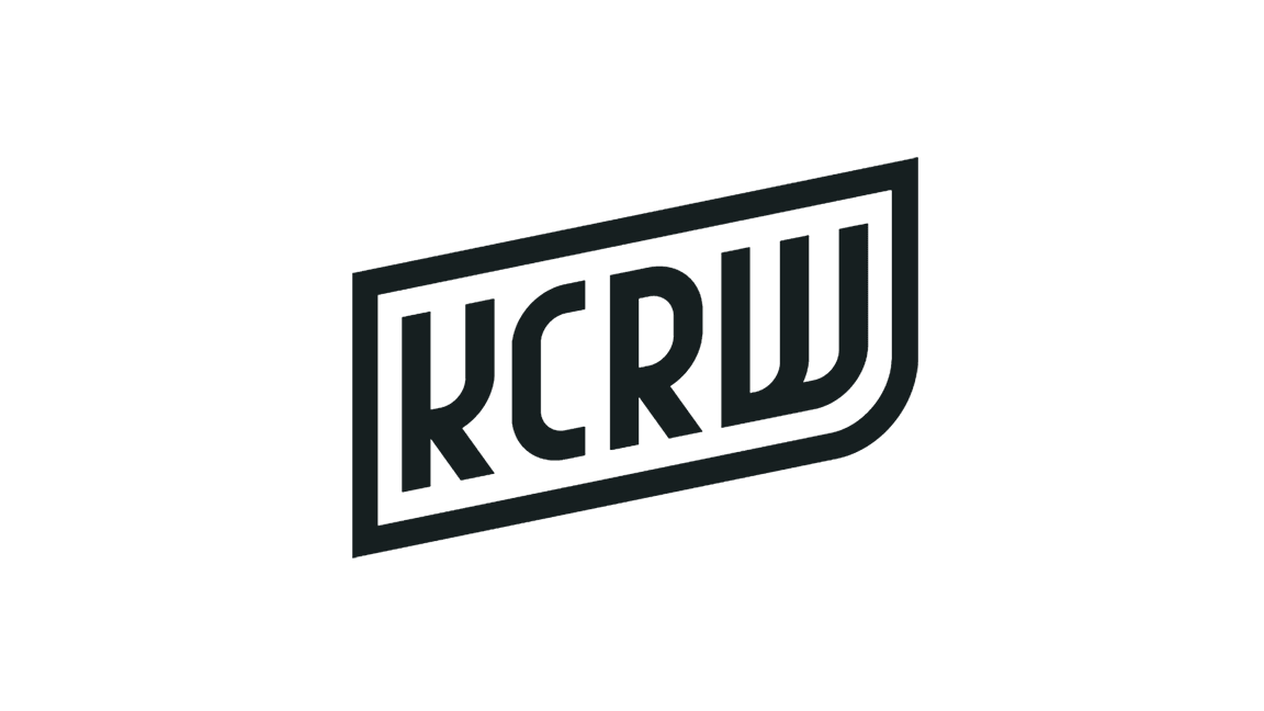 Black and white logo with the text 'KCRW' inside a stylized rectangular frame.