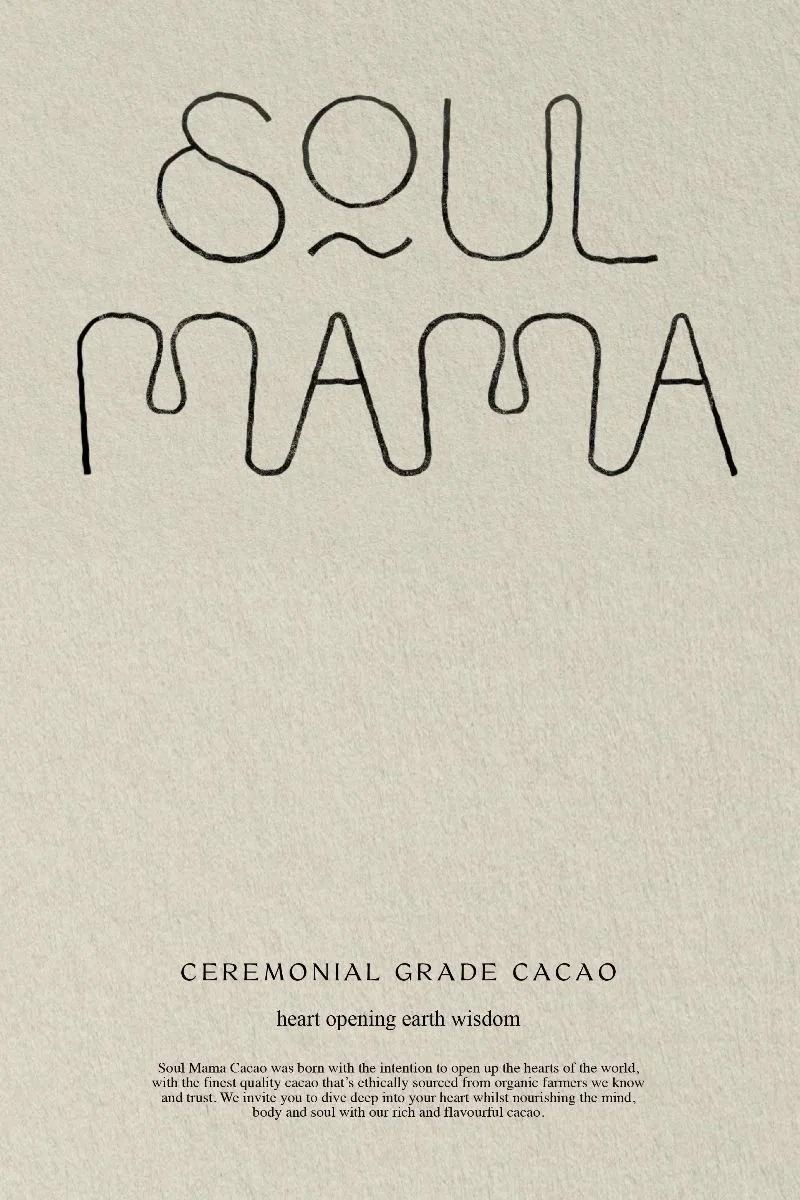 A handwritten phrase reading 'Soul Mama' on a cream-colored background, with a printed text below that says 'Ceremonial Grade Cacao' and additional information about cacao.