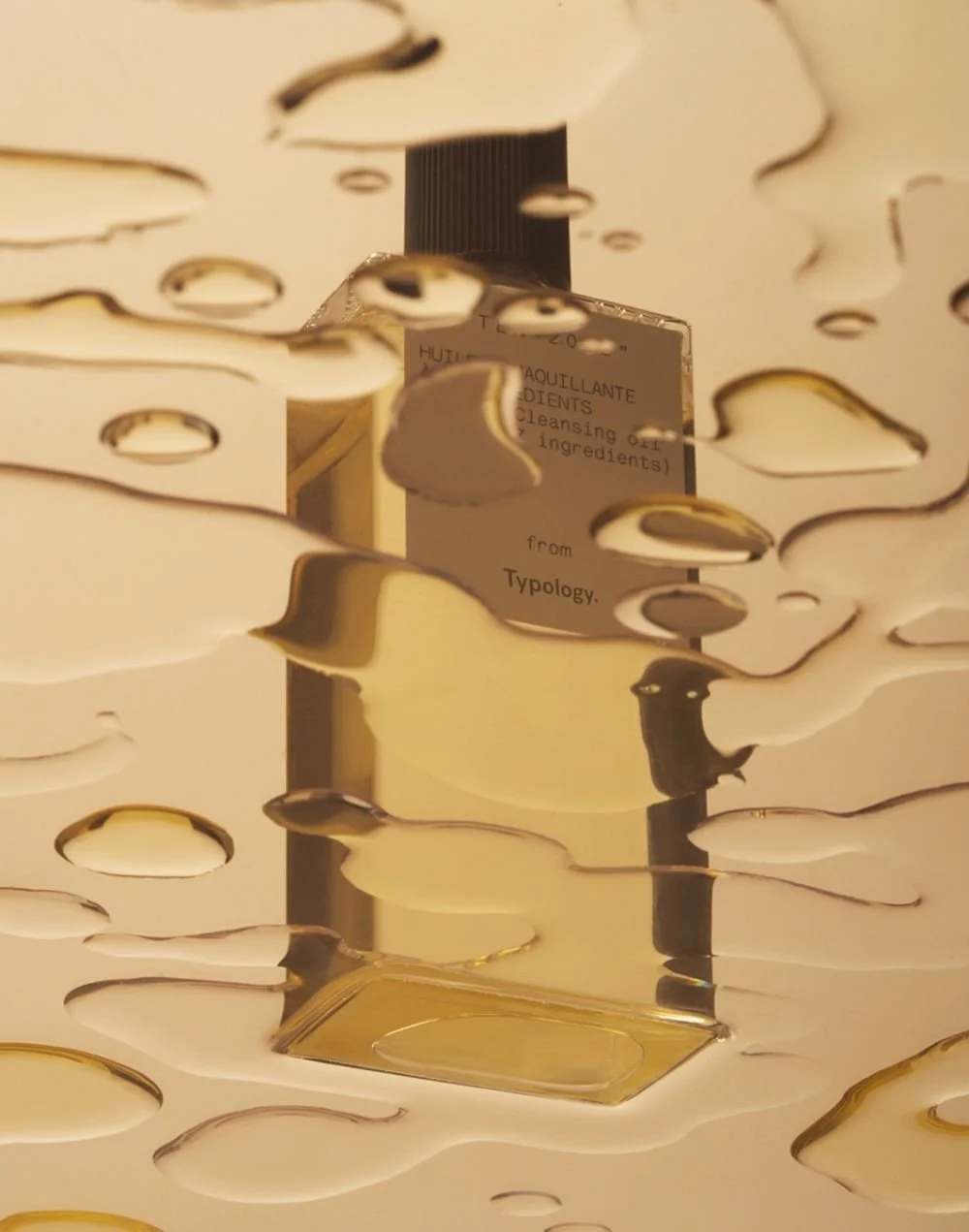 Reflected image of a cleansing product bottle seen through a decorative surface with irregular holes, with the label partially visible.