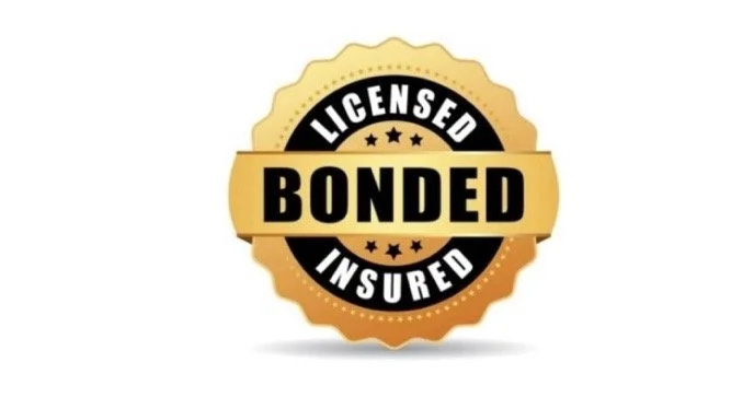 Gold and black badge with the text "Licensed, Bonded, Insured". Credential with Julia Lansdell, Notary public in Tupelo, MS.