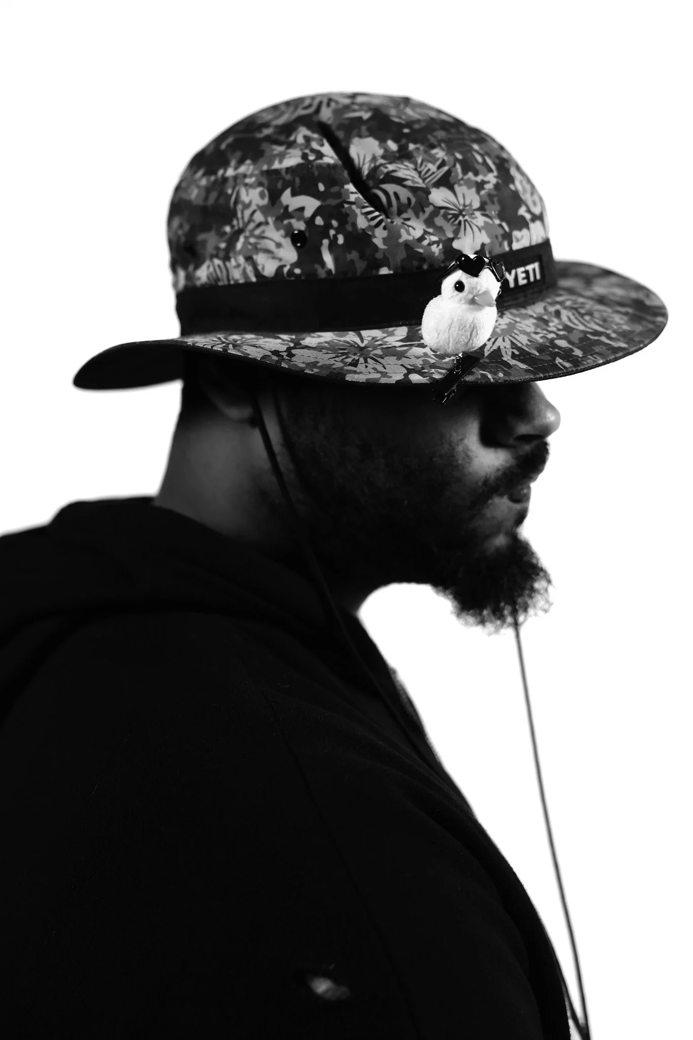 Black and white photo of Ramon with a fake duck on his hat