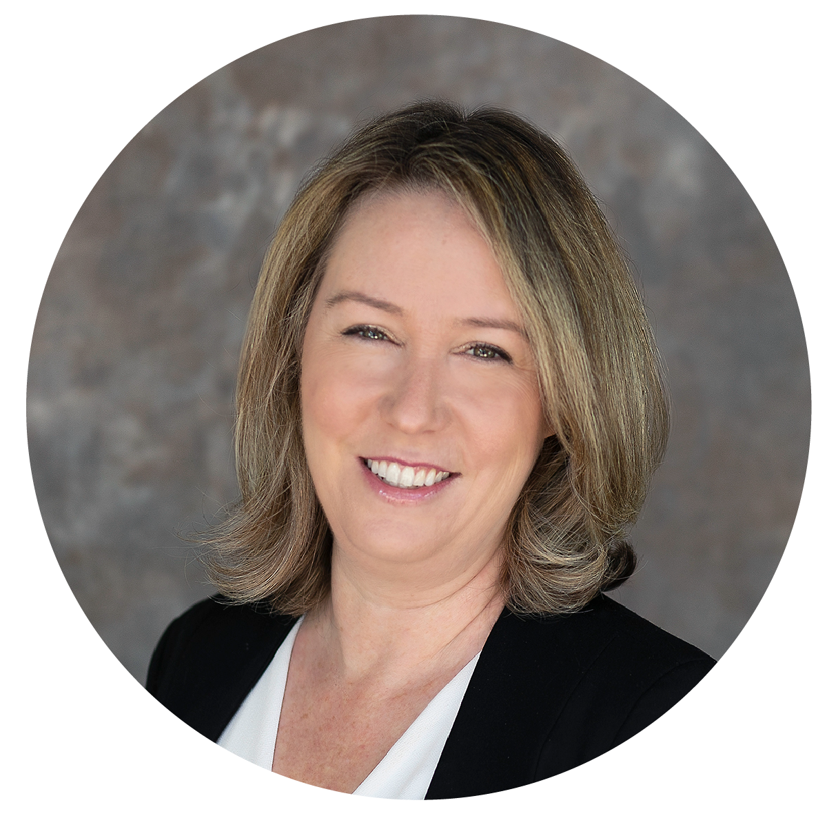 Headshot of a woman with shoulder-length light brown and blonde hair, smiling, wearing a black blazer and white blouse, against a gray textured background.