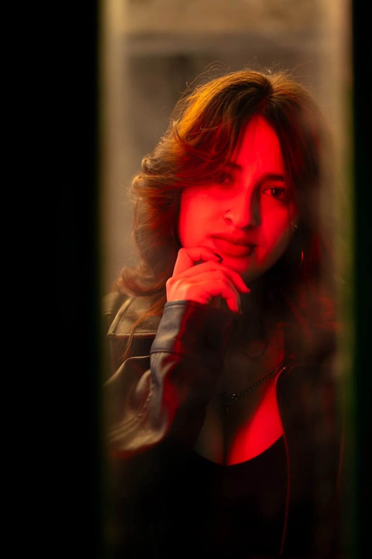 Graphic design student Ariz posing in dramatic red lighting at a Humber College parking garage in Etobicoke.
