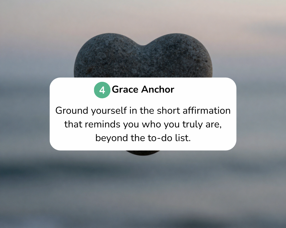 A heart-shaped stone balanced on a smaller stone, with a blurred natural background.