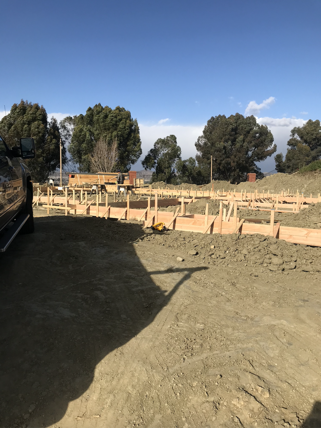 Construction site with wooden forms for building a foundation.