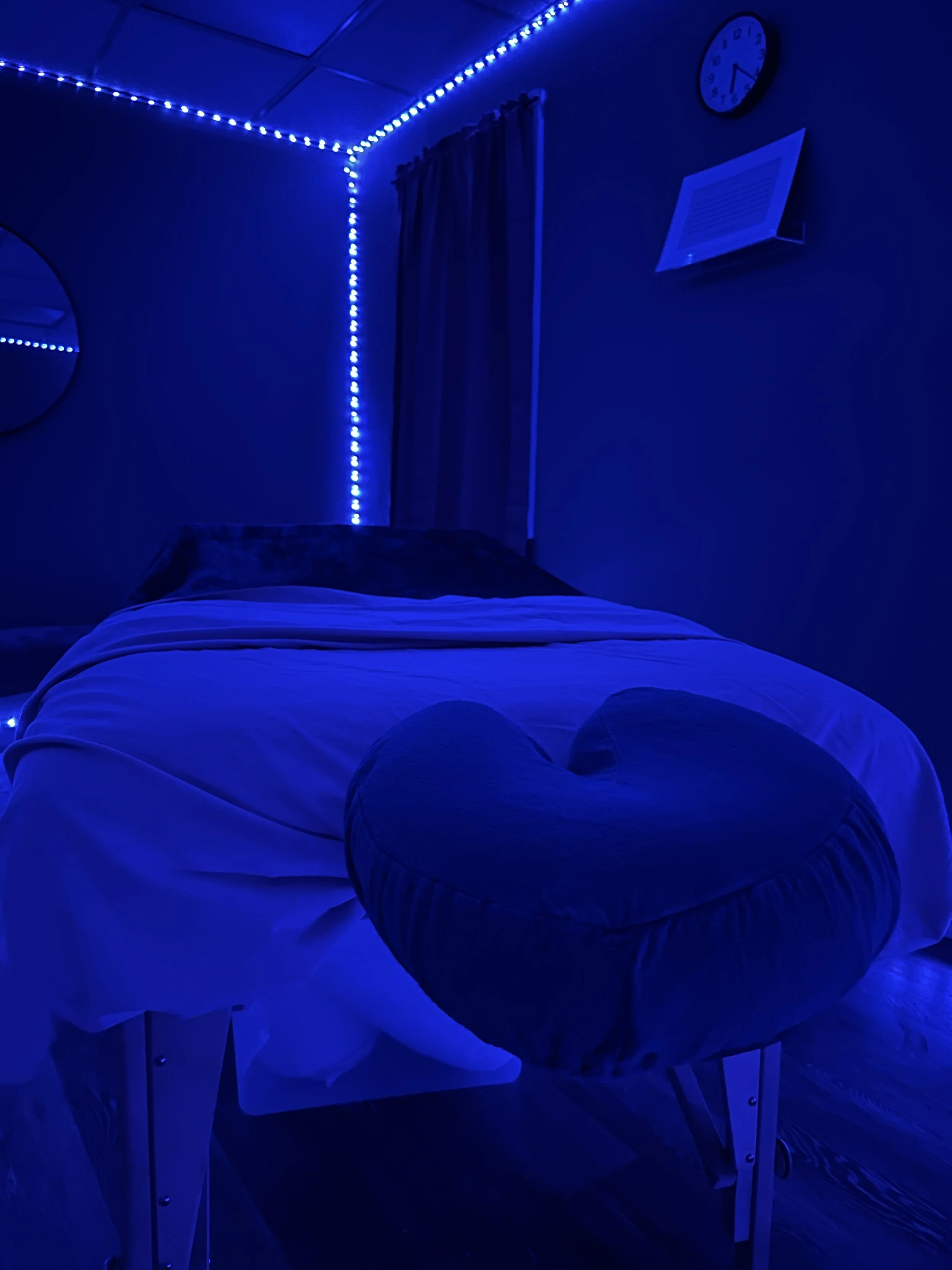 massage table in a room with blue lights