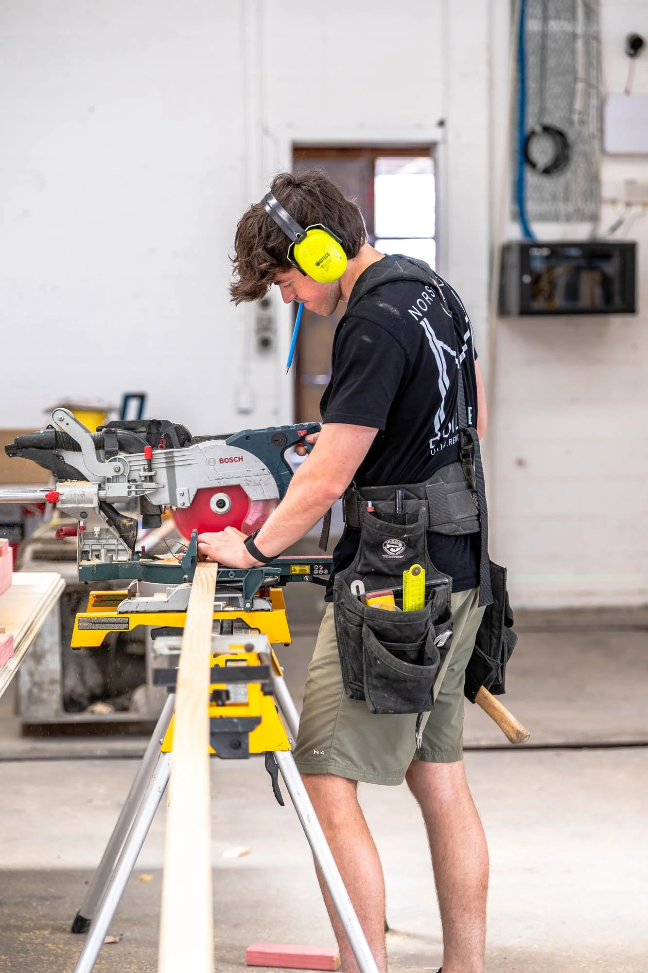 Qualified builder cutting timber on a Norsewood Builders commercial job site