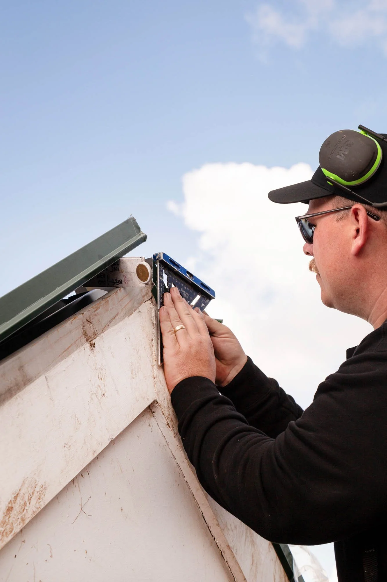 Norsewood Builders' owner Nick Picton, installing exterior flashing and cladding for a project in Pt England
