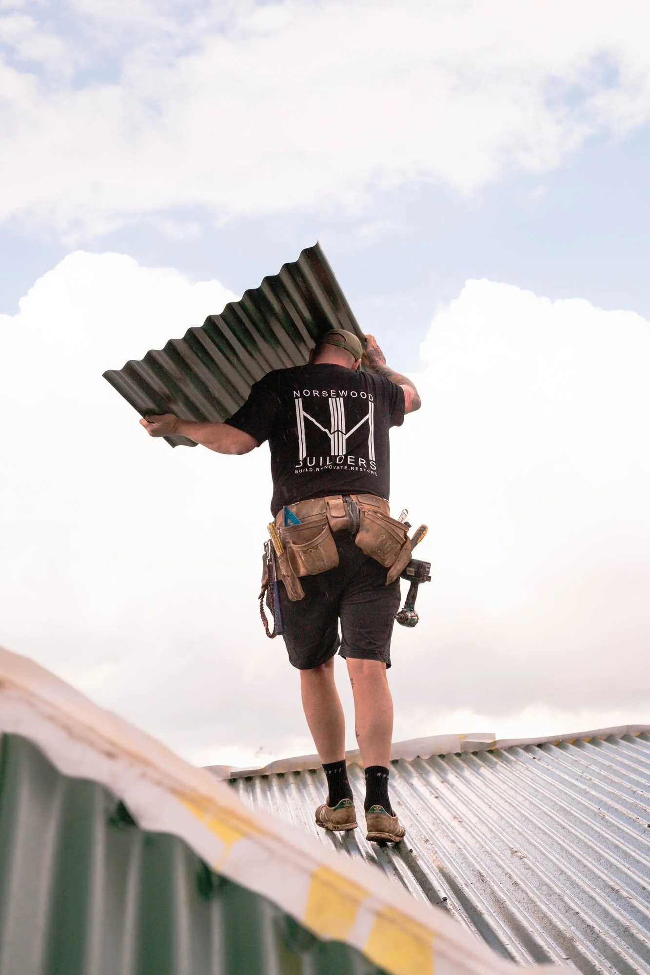 Norsewood Builders' builder working on an exterior reroofing project in Pt England