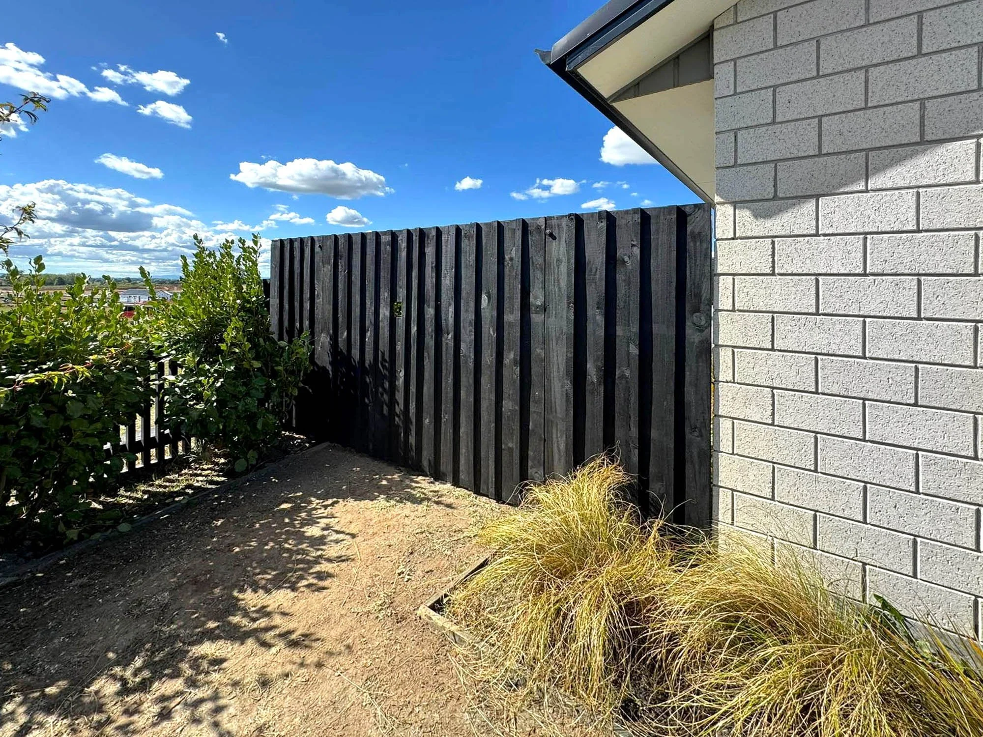 Completed timber privacy fence installed and painted by Norsewood Builders in Waikato