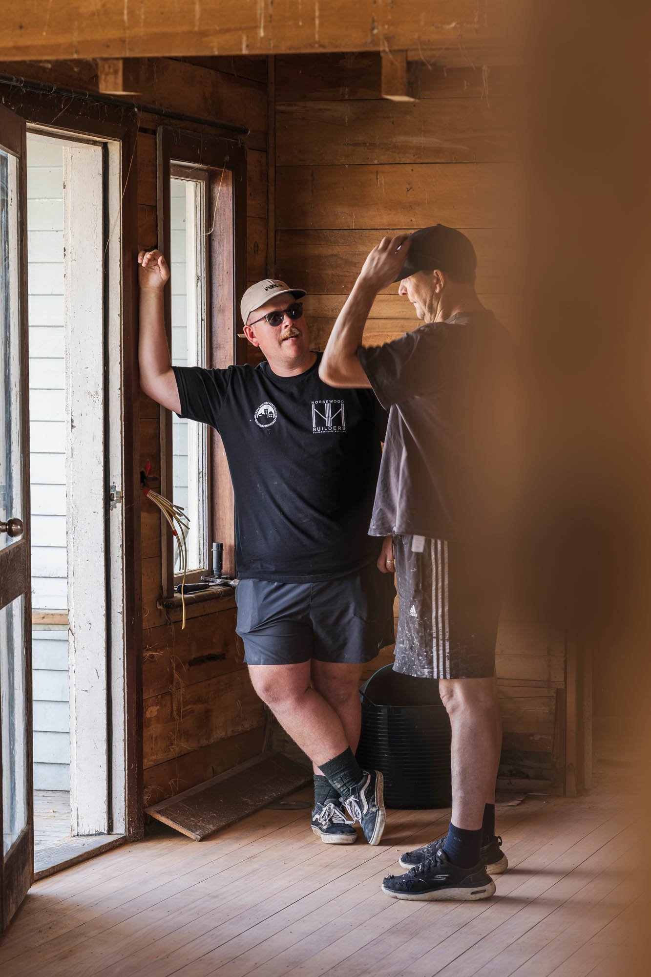 Norsewood Builders' owner Nick Picton, liaising with a contractor for planned restoration work inside a heritage home renovation project in Morrinsville