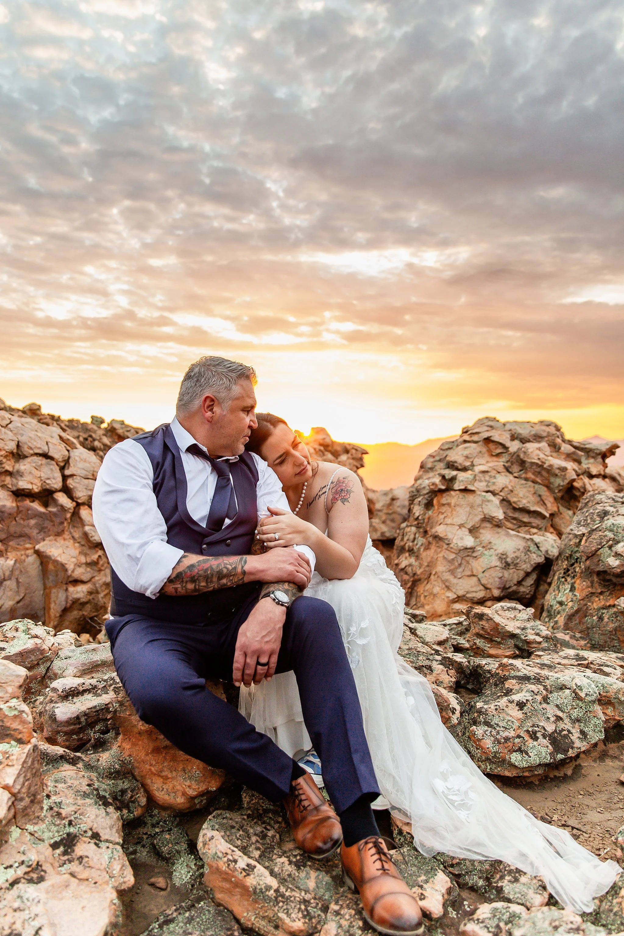 Laurie’s customers, Mariana and Carmen holding hands on a green lawn on their wedding day.